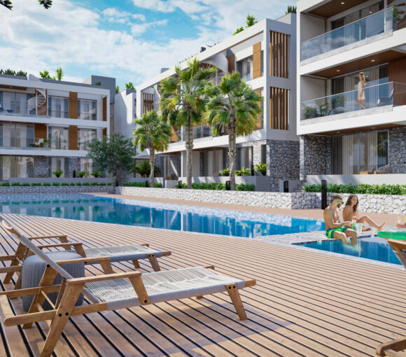 Ontdek het toppunt van luxe leven in Noord-Cyprus op Olive Hill, gelegen in de schilderachtige regio Alsancak, ten westen van Kyrenia. Deze luxe 2+1 appartementen, in totaal 90 eenheden, beloven een adembenemend uitzicht op zowel de bergen als de zee. Elk appartement is zorgvuldig ontworpen om privétuinen, balkons en terrassen te bieden, zodat bewoners kunnen genieten van de fascinerende zonsopgangen en zonsondergangen van de Middellandse Zee. De toplocatie van Olive Hill ligt op slechts een steenworp afstand van het gewaardeerde Necat British College. Op slechts 10 minuten rijden vindt u het hart van Kyrenia, een stad die bekend staat om zijn rijke geschiedenis en levendige cultuur. Gemak staat voorop, met essentiële voorzieningen zoals ziekenhuizen, markten, tankstations, eetgelegenheden, apotheken, salons, winkels en uitgaansgelegenheden allemaal binnen handbereik. Voor degenen die van stranddagen houden, ligt de Camelot Beach Club, een van de mooiste stranden van Kyrenia, op loopafstand. Andere nabijgelegen bezienswaardigheden zijn onder meer het Merit Hoteller-gebied, de Amerikaanse universiteit en hogescholen van Girne, het Freedom Park van Alsancak, het voetgangersgebied van Lapta en de Escape Beach Club. De oplevering staat gepland voor het 2e kwartaal van 2024 en elk appartement beschikt over een hoogwaardige afwerking. De keukens zijn uitgerust met Bosch apparatuur, Lapitec/Italstone werkbladen en hoogwaardig laminaat. Bewoners zullen genieten van de luxe van IP-intercoms, centrale satelliet-tv en internet. Het interieur is versierd met hoogwaardige gelamineerde parketvloeren, natuurlijk marmer op de balkons, terrassen met keramische coating en warmte-geïsoleerde aluminium ramen met dubbele beglazing. De badkamers zijn ontworpen met een moderne esthetiek, met hangende toiletten, wastafels, platte douches en kasten van gehard glas. Veiligheid staat voorop, met een CCTV-camerasysteem, slagboomsysteem en een centraal generatorsysteem. De gemeenschappelijke voorzieningen zijn even indrukwekkend. Duik in het uitgestrekte zwembad voor volwassenen of laat de kleintjes spetteren in het kinderbad. Het parkgebied, omgeven door olijfbomen van 2000 m2, biedt een serene ontsnapping. Het landschapsontwerp, gecombineerd met een kinderspeelplaats, zorgt ervoor dat bewoners van alle leeftijden ruimtes hebben om te ontspannen en te spelen. Voor degenen die een investering in Noord-Cyprus overwegen, is Olive Hill niet alleen een woning; het is een levensstijl. Ervaar de allure van de Middellandse Zee, gecombineerd met moderne gemakken en gemakken, direct voor de deur.